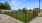 a dog park with a black fence