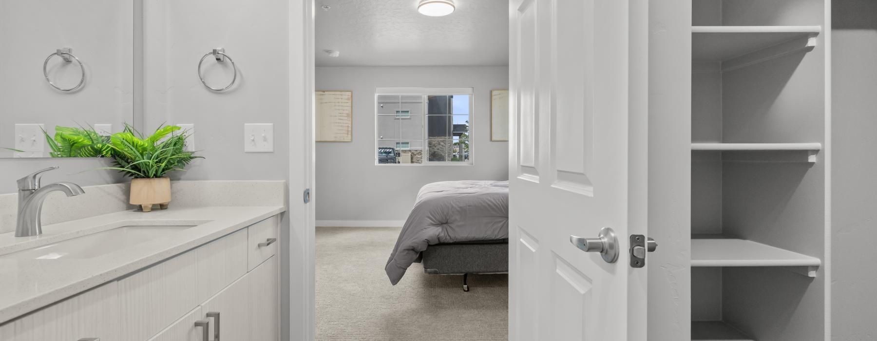 a bathroom with white cabinets